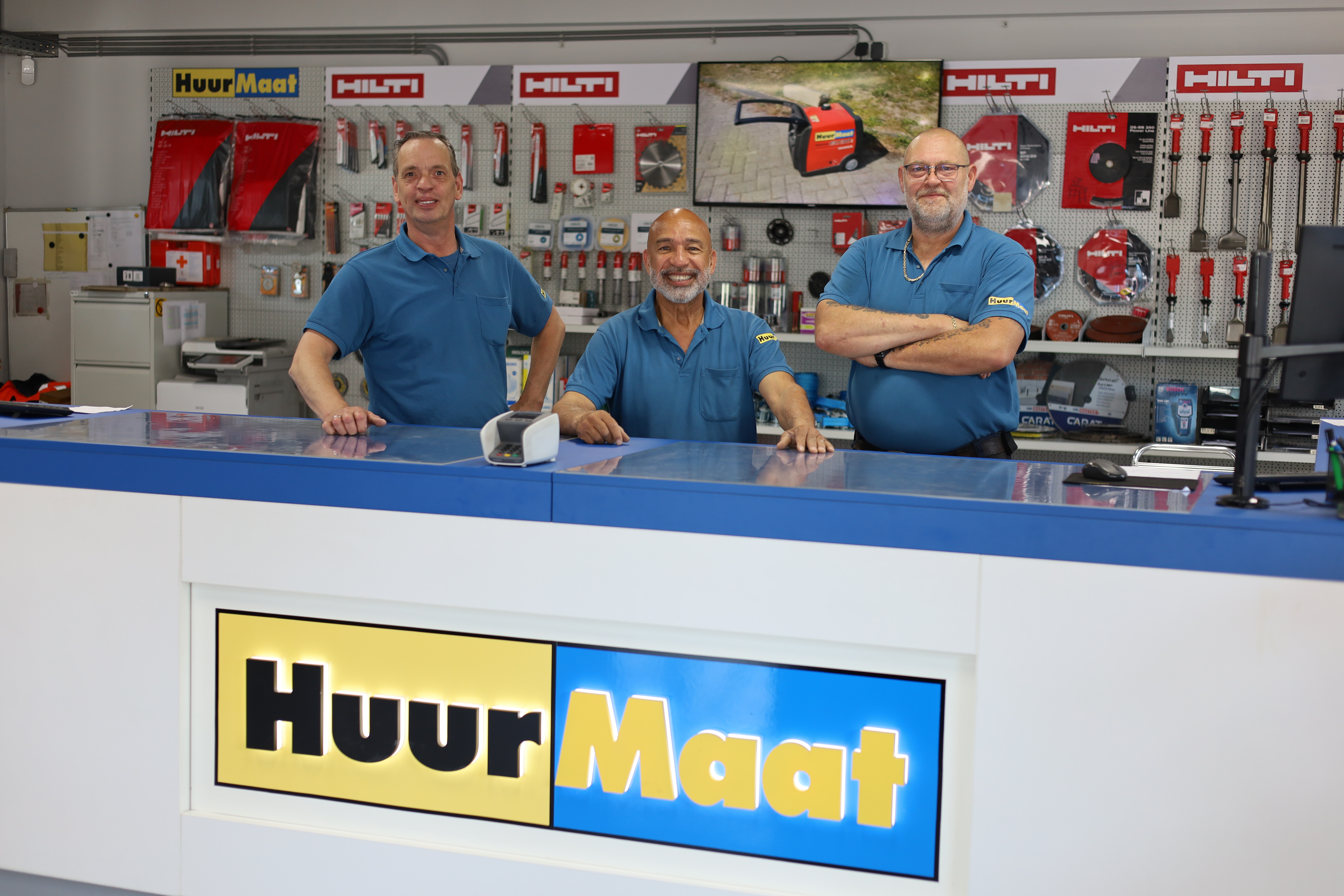 Drie HuurMaat-medewerkers in de verhuurshop